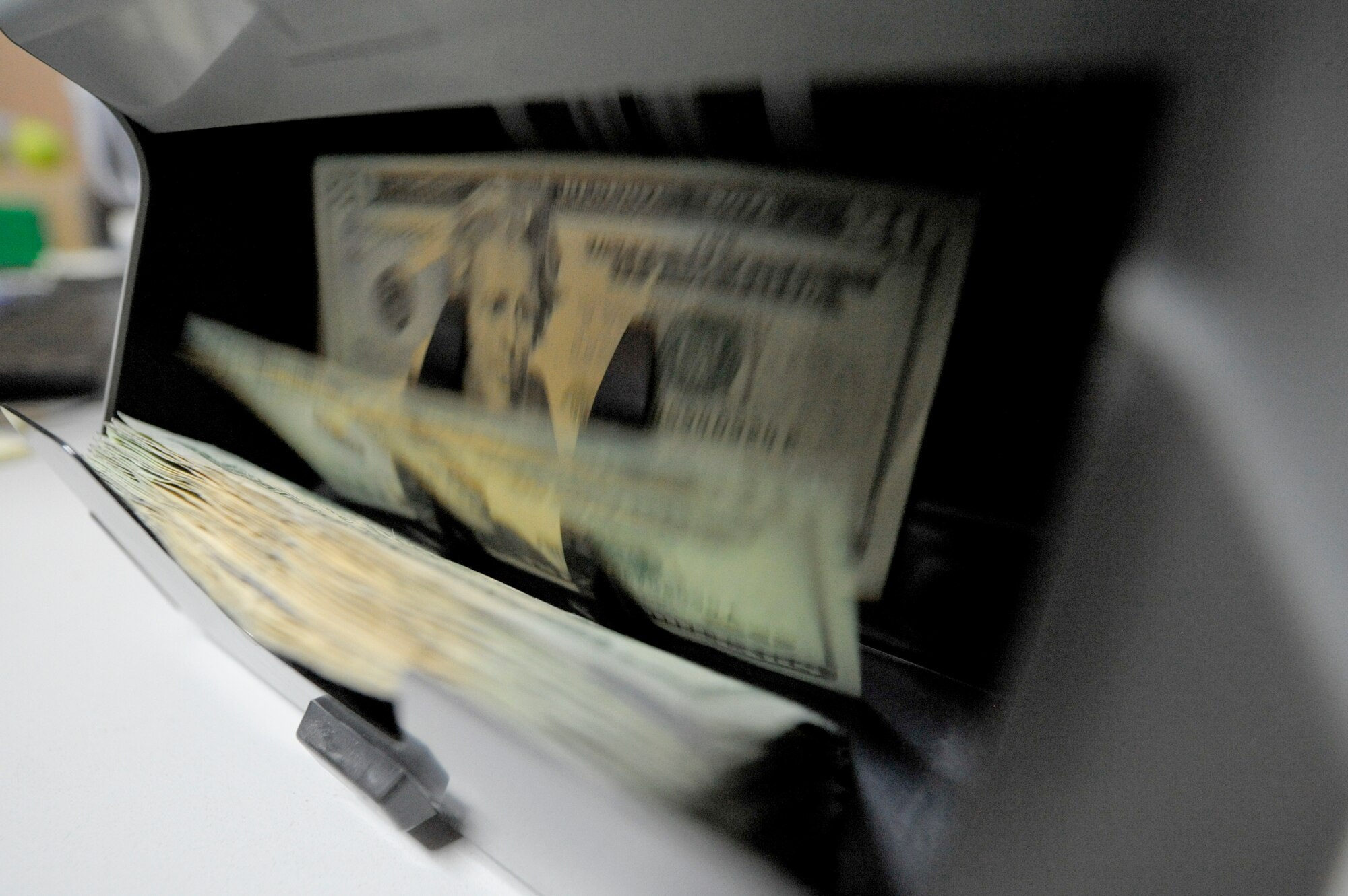 A stack of money is counted at an undisclosed location in Southwest Asia, Feb. 10, 2012. The 332nd Air Expeditionary Wing financial management flight handles host nation and American currencies. (U.S. Air Force photo by Staff Sgt. Joshua J. Garcia/Released)