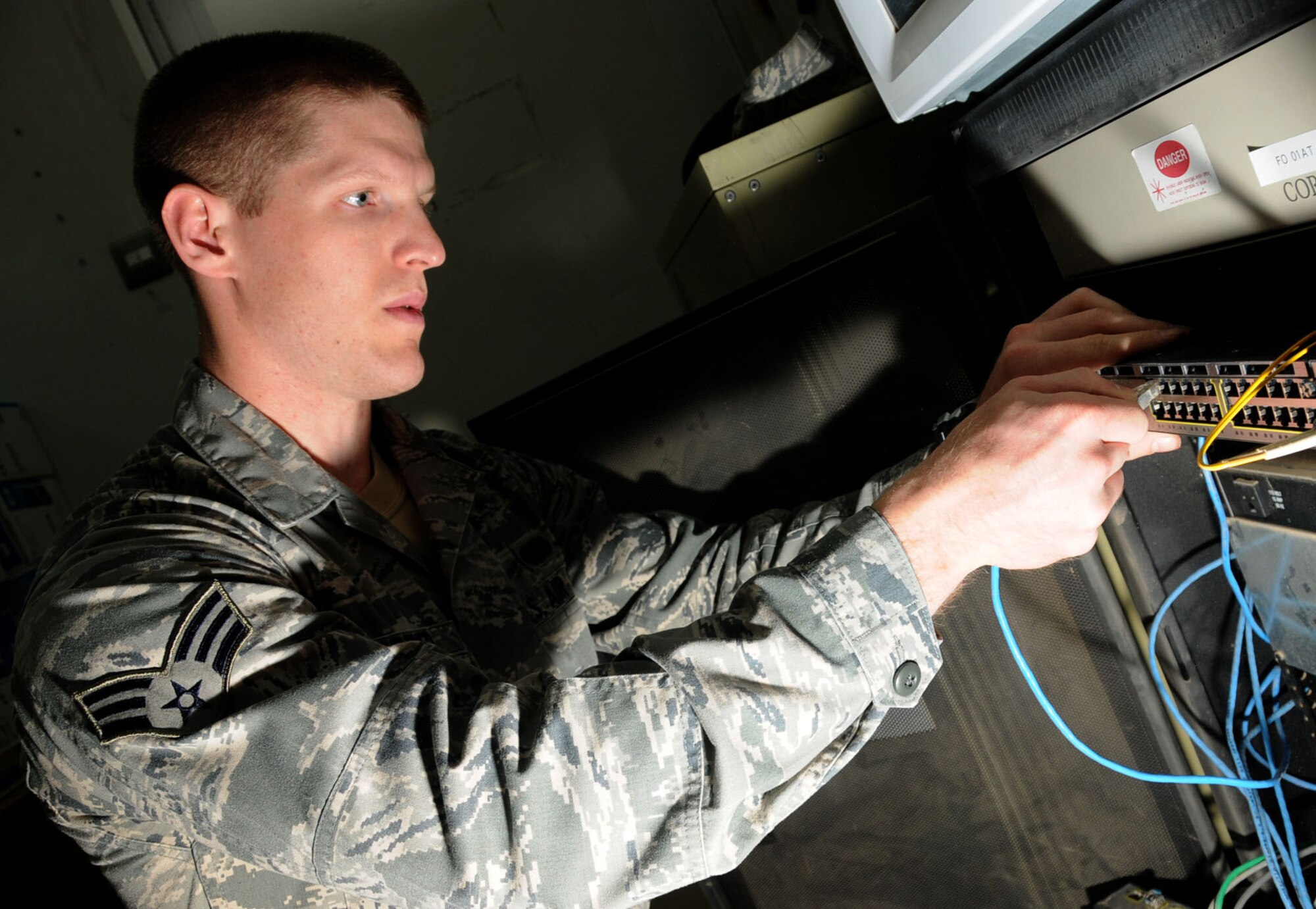 U.S. Air Force Senior Airman William Fortner, 386th Expeditionary Communication Squadron, installs a new network module at an undisclosed location in Southwest Asia Feb. 8, 2012. Fortner, a Battle Creek, Mich., native deployed from the 39th Communications Squadron, Incirlik Air Base, Turkey, installed a new network module to optimize connectivity in the public affairs office for the 386th Air Expeditionary Wing. (U.S. Air Force photo by Staff Sgt. James Lieth/Released)