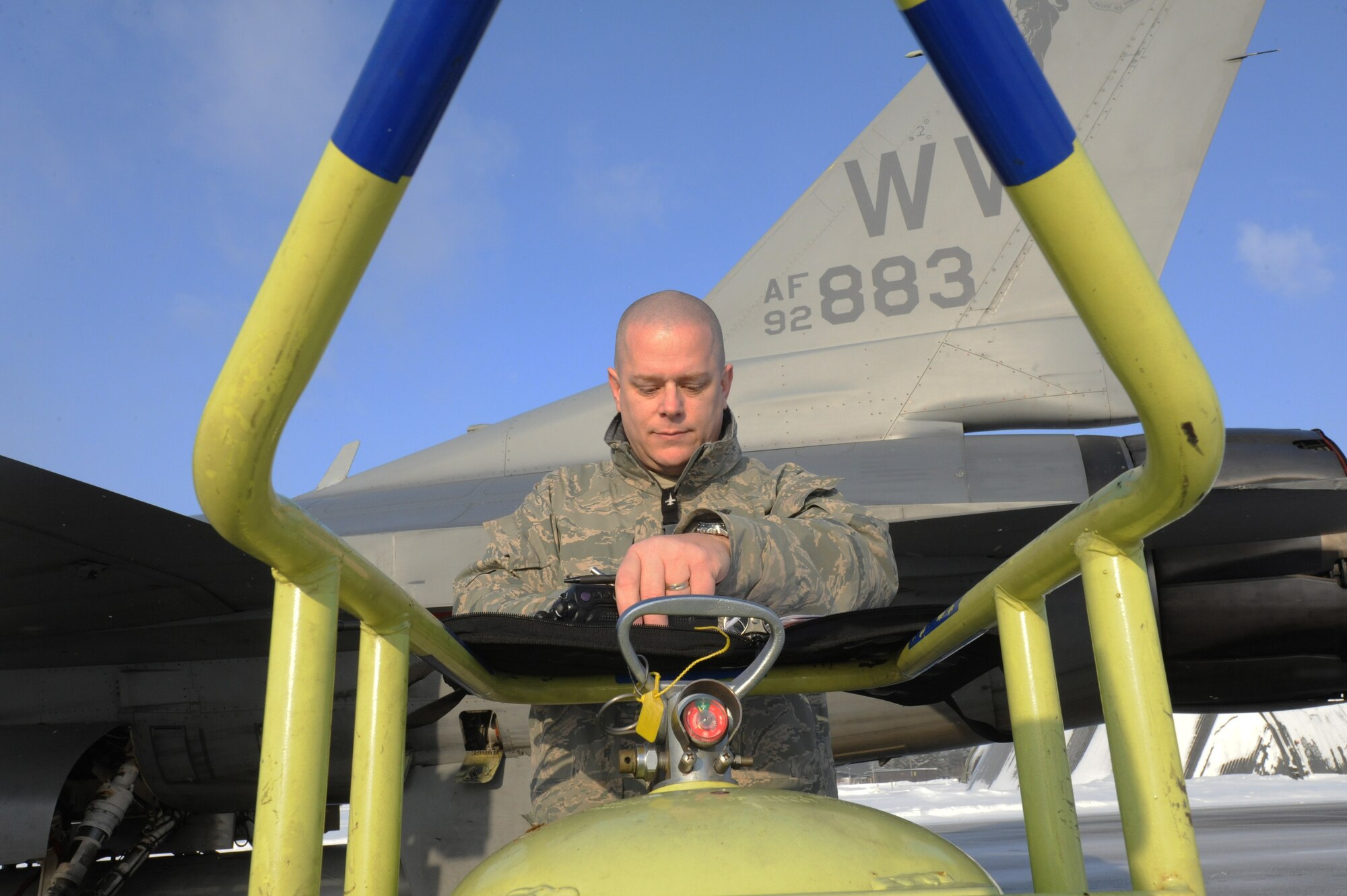 MISAWA AIR BASE, Japan – Master Sgt. Bruce Wark, 13th Aircraft Maintenance Unit production superintendent, signs an exceptional release on a F-16 Fighting here, Jan. 24. An exceptional release is a certification from the production superintendent that the aircraft is mission capable. Prior to take off, aircraft is inspected several times to ensure the pilot is safe during his flight. (U.S. Air Force photo/Airman Kenna Jackson)