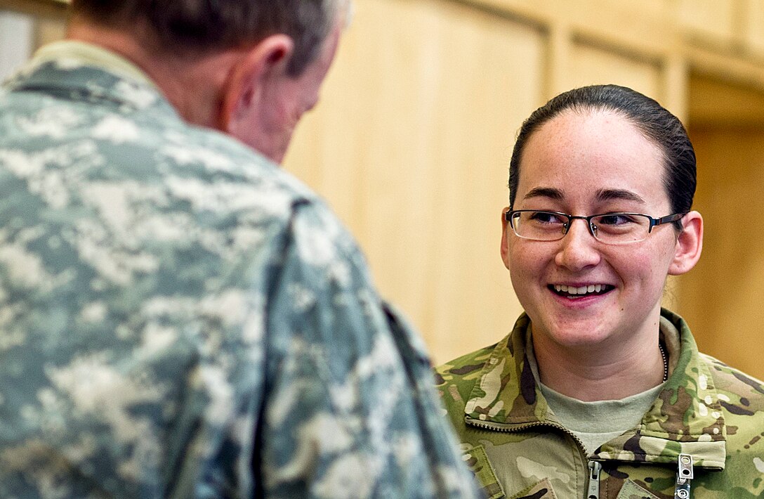U.S. Army Spc. Kristen Taylor talks with U.S. Army Gen. Martin E. Dempsey, chairman of the Joint Chiefs of Staff, in the tactical operations center on Forward Operating Base Shank, Afghanistan, Feb. 10, 2012.