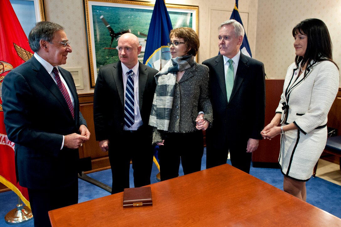 Defense Secretary Leon E. Panetta speaks with Mark Kelly, former U.S. Rep. Gabrielle Giffords of Arizona, Navy Secretary Ray Mabus and Roxanna Green at the Pentagon, Feb. 10, 2012.