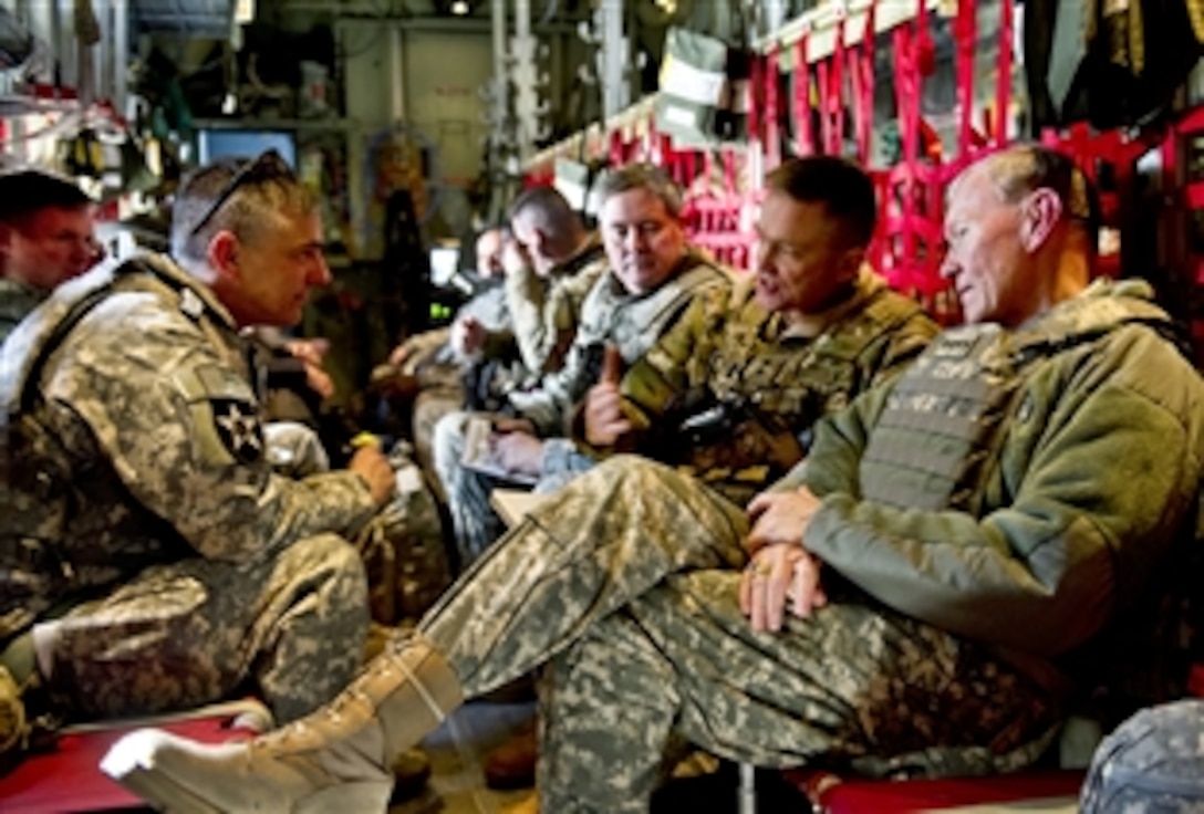 From right to left, U.S. Army Gen. Martin E. Dempsey, chairman of the Joint Chiefs of Staff; U.S. Army Maj. Gen. Daniel B. Allyn, commander of Regional Command East in Afghanistan; U.S. Army Brig. Gen. Terry A. Wolff, director of strategic plans and policy, J5; and U.S. Army Brig Gen. Steve Townsend talk about current operations while flying in a C-130 over Afghanistan, Feb. 10, 2012.