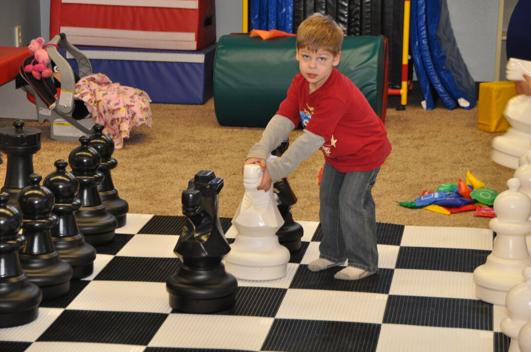Aboard Marine Corps Logistics Base Barstow, Colton Sheehy-Perry takes on the fundamentals of moving a giant knight chess piece during the grand opening of the multipurpose room in building 375 Feb. 10.