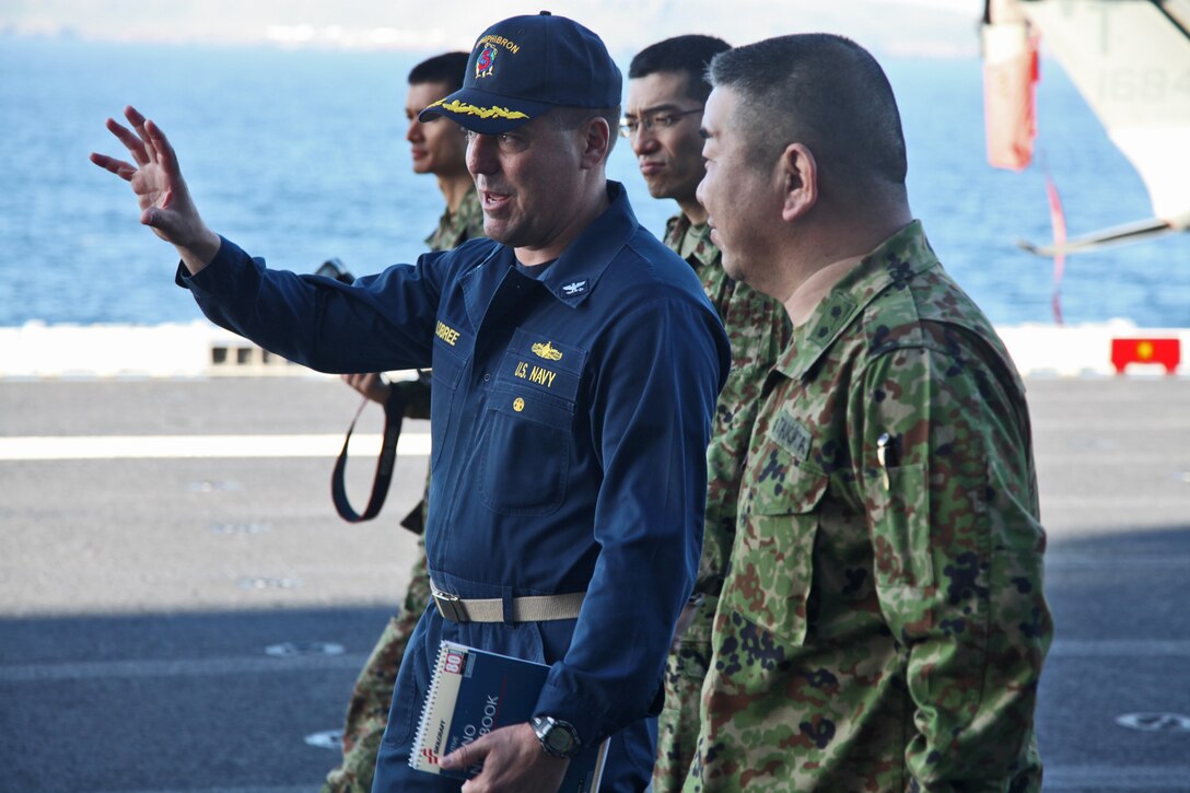 Navy Capt. Shawn Lobree, deputy commander, Amphibious Squadron 3, shows Major General Katsuki Takata, deputy chief of staff for operations, Western Army, the flight deck of the USS Peleliu, Feb. 10. Marines and sailors with the 15th Marine Expeditionary Unit, and soldiers with the Japanese Ground Self Defense Force, are participating in a week-long at-sea period during Exercise Iron Fist 2012.  The exercise encompasses all aspects of the Marine Air Ground Task Force during the training on San Clemente Island and provides the Navy/Marine Corps team an opportunity to practice its craft. Exercise Iron Fist 2012 is a bilateral training exercise, which gives the 15th MEU a chance to demonstrate its amphibious capabilities to the Japanese.