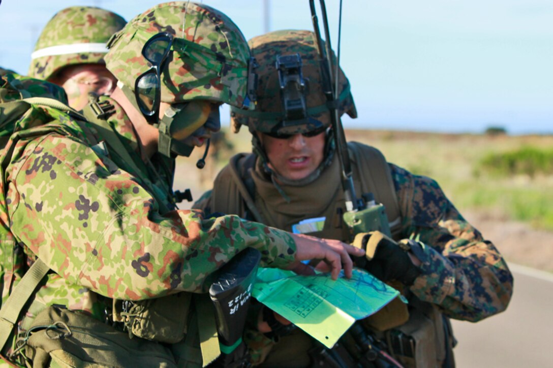 Second Lt. Jeff D. Illies Jr., platoon commander, 1st Platoon, Alpha Co., 3rd Amphibious Assault Battalion, discusses the route plans with a Japanese infantry platoon commander during an eight-and-a-half mile patrol as a part of the weeklong at-sea portion of Exercise Iron Fist 2012, on San Clemente Island, Calif., Feb. 10. The Marines of 1st Platoon moved from the USS Peleliu to the island in CH-53E Super Stallion helicopters. Third AABN acted as the ground combat element for the exercise. Exercise Iron Fist 2012 is a bilateral training exercise that gave the 15th MEU a chance to demonstrate its amphibious capabilities to the Japanese. Illies, 27, is a native of Muskego, Wis.