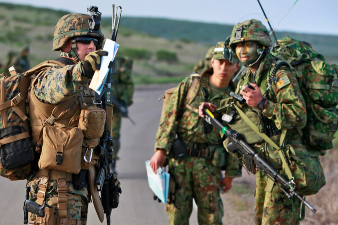Second Lt. Jeff D. Illies Jr., platoon commander, 1st Platoon, Alpha Co., 3rd Amphibious Assault Battalion, gives guidance to soldiers with the intelligence platoon, Japanese Ground Self Defense Force, during an eight-and-a-half mile patrol as a part of the weeklong at-sea portion of Exercise Iron Fist 2012, on San Clemente Island, Calif., Feb. 10. The Marines of 1st Platoon moved from the USS Peleliu to the island in CH-53E Super Stallion helicopters. Third AABN acted as the ground combat element for the exercise. Exercise Iron Fist 2012 is a bilateral training exercise that gave the 15th MEU a chance to demonstrate its amphibious capabilities to the Japanese. Illies, 27, is a native of Muskego, Wis.