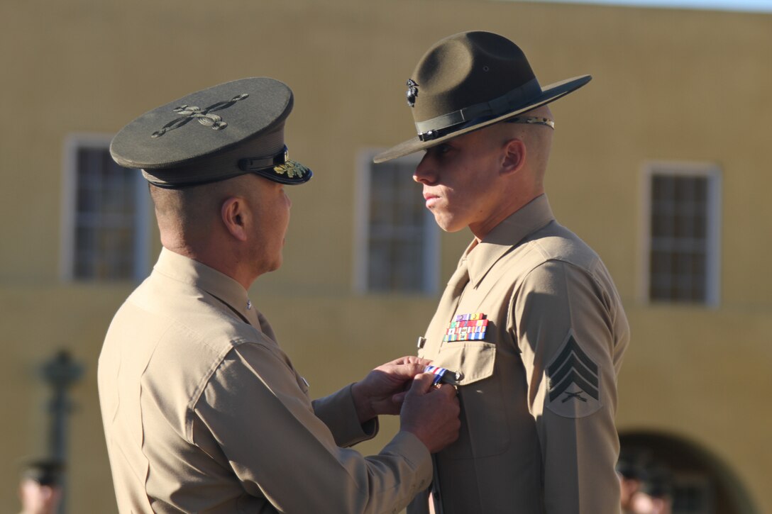 Brig. Gen. Daniel D. Yoo, commanding general, Marine Corps Recruit Depot San Diego and the Western Recruiting Region, pins a Silver Star on Sgt. Phillip A. McCulloch Jr., drill instructor, Company M, 3rd Recruit Training Battalion, during the morning colors ceremony aboard MCRD Feb 10. McCulloch was awarded the medal for his actions during a six-hour engagement with insurgent forces in the Sangin District in support of Operation Enduring Freedom Jan. 8, 2011.