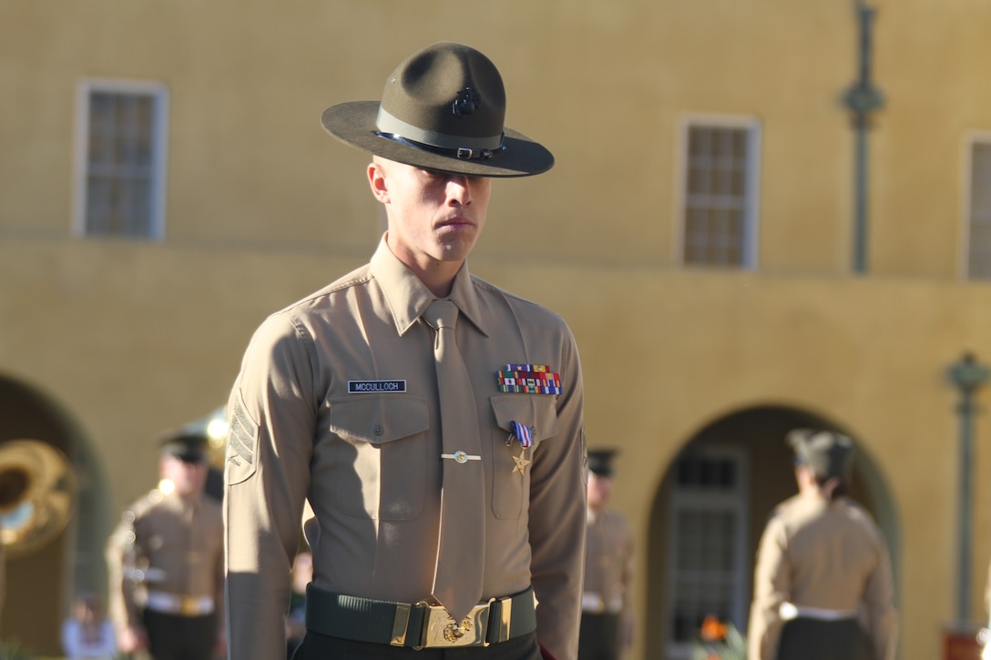 Sgt. Phillip A. McCulloch Jr., drill instructor, Company M, 3rd Recruit Training Battalion, steps off after recieving a Silver Star during the morning colors ceremony aboard Marine Corps Recruit Depot San Diego Feb. 10. McCulloch was awarded the medal for his actions during a six-hour engagement with insurgent forces in the Sangin District in support of Operation Enduring Freedom Jan. 8, 2011.