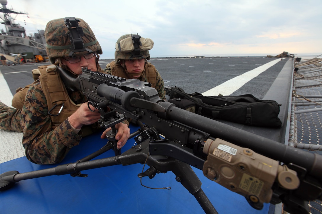 Lance Cpl. Neil Lipon and Pfc. Kyler Ramsey, machine gunners with Charlie Company, Battalion Landing Team 1st Battalion, 2nd Marine Regiment, 24th Marine Expeditionary Unit hold security on the ship’s flight deck during a Defense of the Amphibious Task Force training exercise, Feb 10. While at sea, Marines and Sailors must be prepared to guard the ship whenever it passes a danger area or when there may be an increased threat to the force. The training exercise was a smaller part of the 24th MEU’s Certification Exercise (CERTEX) with the Iwo Jima Amphibious Ready Group, scheduled Jan. 27 to Feb. 17, which includes a series of missions intended to evaluate and certify the unit for their upcoming deployment.