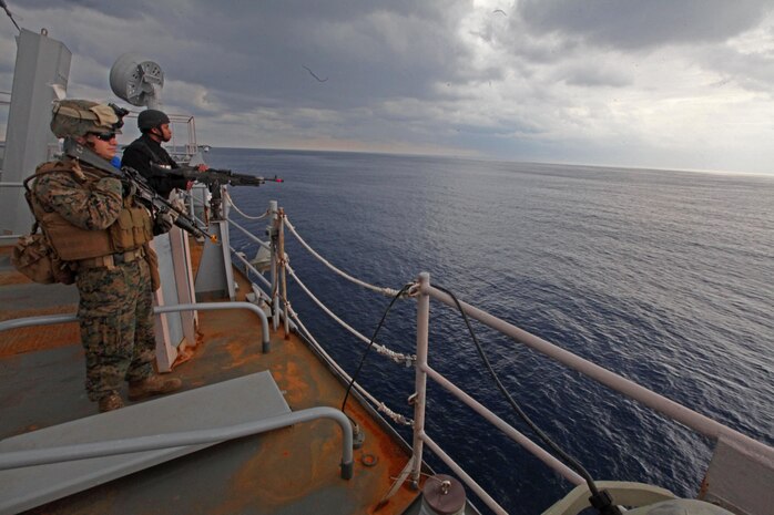 Cpl. Stephen Rockwell, a rifleman with Charlie Company, Battalion Landing Team 1st Battalion, 2nd Marine Regiment, 24th Marine Expeditionary Unit, and Seaman Ricky Donaldson, an information system technologist with the USS Gunston Hall, hold security on the top of the ship during a Defense of the Amphibious Task Force training exercise, Feb 10. While at sea, Marines and Sailors must be prepared to guard the ship whenever it passes a danger area or when there may be an increased threat to the force. The training exercise was a smaller part of the 24th MEU’s Certification Exercise (CERTEX) with the Iwo Jima Amphibious Ready Group, scheduled Jan. 27 to Feb. 17, which includes a series of missions intended to evaluate and certify the unit for their upcoming deployment.