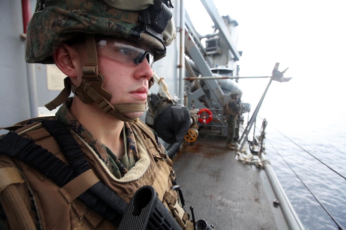 Cpl. Darrell Kincaid, a team leader with Charlie Company, Battalion Landing Team 1st Battalion, 2nd Marine Regiment, 24th Marine Expeditionary Unit, holds security on the side of the ship in the rain during a Defense of the Amphibious Task Force training exercise, Feb 10. While at sea, Marines and Sailors must be prepared to guard the ship whenever it passes a danger area or when there may be an increased threat to the force. The training exercise was a smaller part of the 24th MEU’s Certification Exercise (CERTEX) with the Iwo Jima Amphibious Ready Group, scheduled Jan. 27 to Feb. 17, which includes a series of missions intended to evaluate and certify the unit for their upcoming deployment.