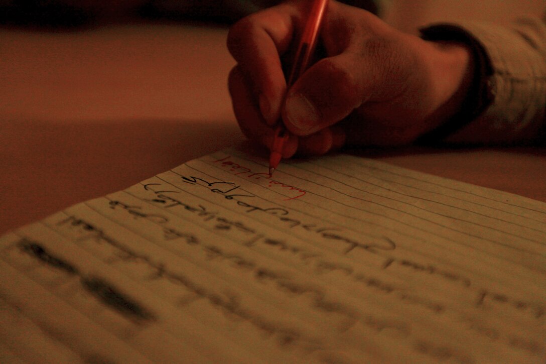 Afghan National Security Forces recruits pay attention to their literacy class at the Joint Security Academy Southwest here, March 30. During the class recruits and students at JSAS learn to read, write, solve simple math problems and about the Consitution of Afghanistan.
