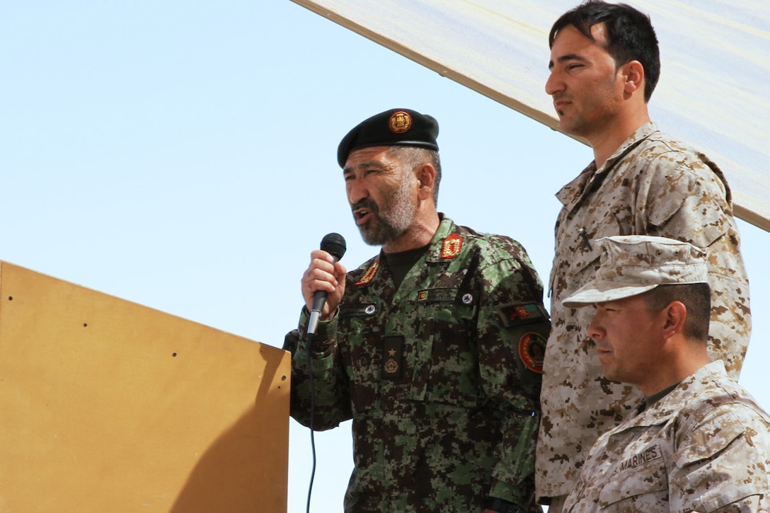 Afghan National Army Brig. Gen. Mohammad Sadiq (left) speaks to the crowd at the Joint Security Academy Southwest graduation of the Trainer Trainee's course and Explosive Hazard Readiness course here, March 31. Sadiq attended the graduation show his gratitude, not only toward the Afghan National Security Forces troops, but to the NATO coalition forces as well.