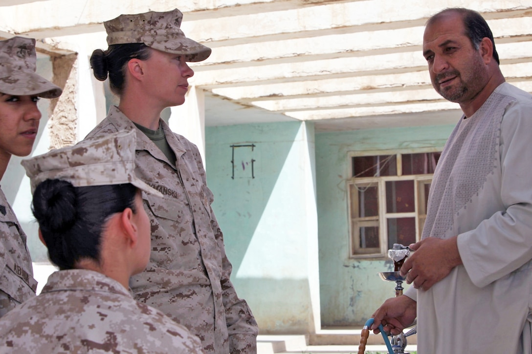 Female Engagment Team Marines, accompanied by Maj. Aniela K. Szymanski (center), the Civil Affairs Group team leader in Now Zad, Helmand province, Afghanistan, greet the district governor, Saied Murad M. Sadat, prior to their meeting at his compound, April 8.  The meeting covered the growth of the Now Zad women's center, the local schools, and other upcoming community improvement projects.