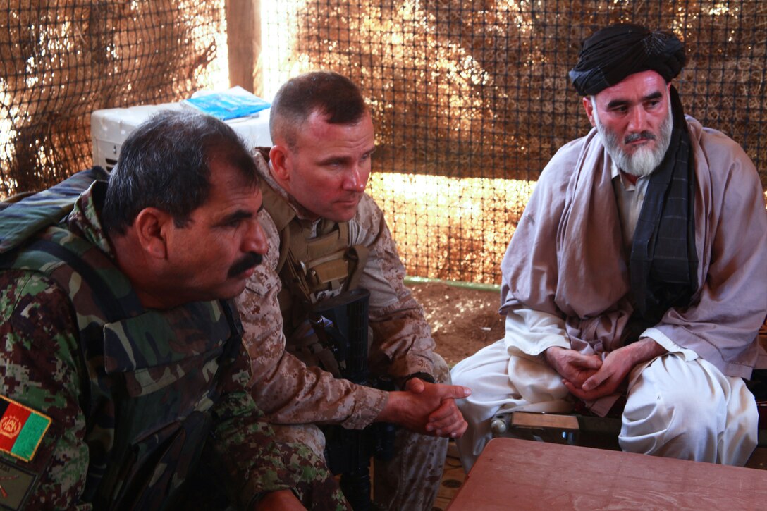 Lt. Col. Todd Zink, the commanding officer of 1st Battalion, 23rd Marine Regiment, listens to local Afghans of Washir district, Helmand province, talk during a shura, August 19. Marines from Weapons Company, 1/23, escorted the Afghan National Army and local government to and from the shura.