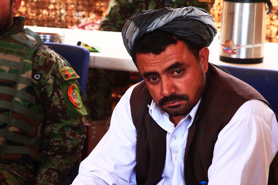 The district governor of Washir district, Helmand province, Daoud Mohammad, listens to others during a shura, which is an Afghan meeting, in Shorab City, August 19. During the shura local men, Afghan National Army soldiers and government officials discussed security and legal issues in the area.