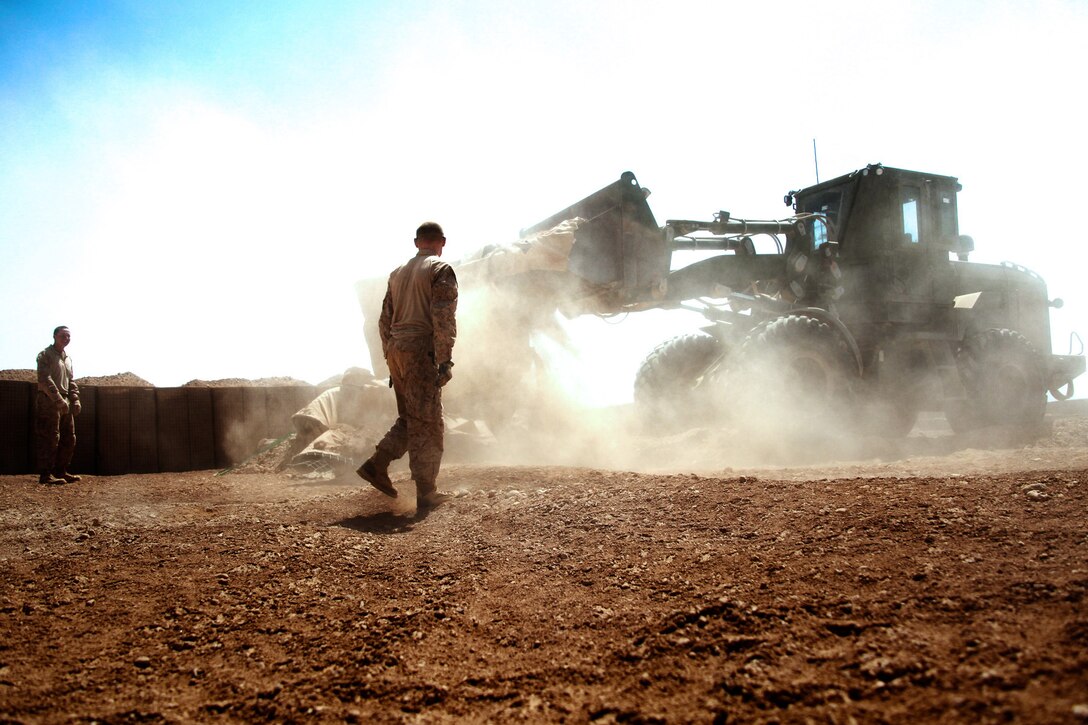 Marines aboard Combat Outpost Ouellette, Helmand province, Afghanistan, work on expanding the Forward Air Refueling Point, April 17. COP Ouellette was built in January by Marines with Battalion Landing Team 3rd Battalion, 8th Marine Regiment and the Naval Mobile Construction Battalion 3.