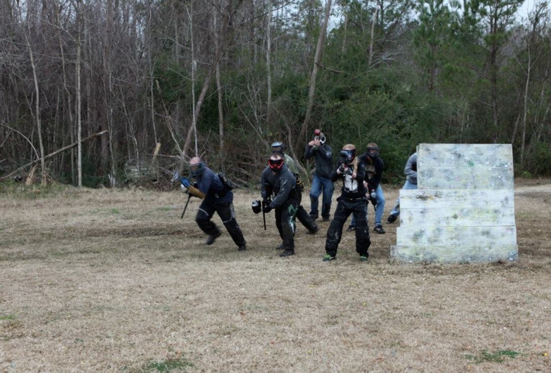 Paintballers lay fire downrange as they try to suppress and defeat the opposing team during a weekend game at a paintball field in Jacksonville, N.C.