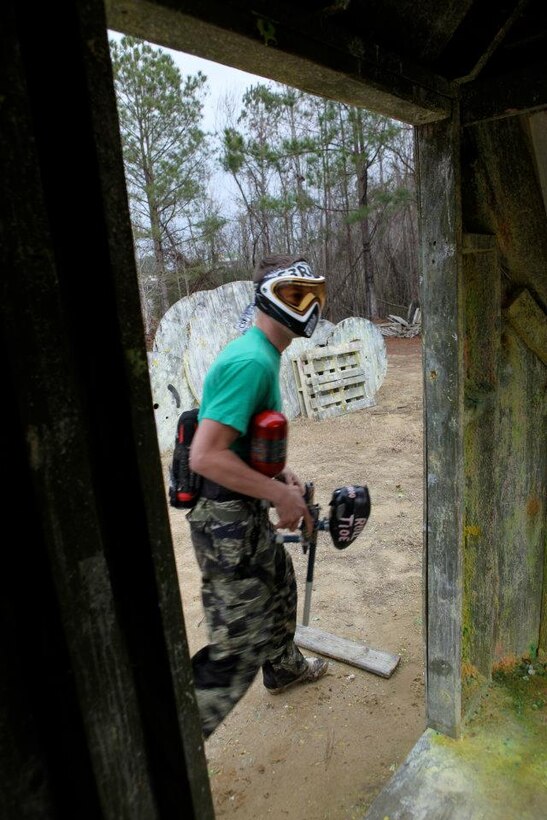 A paintballer passes through a doorframe during a normal weekend of paintballing. Although the SMP's paintball event has passed, service members can still pay their local paintball field for a day of fun and pain.