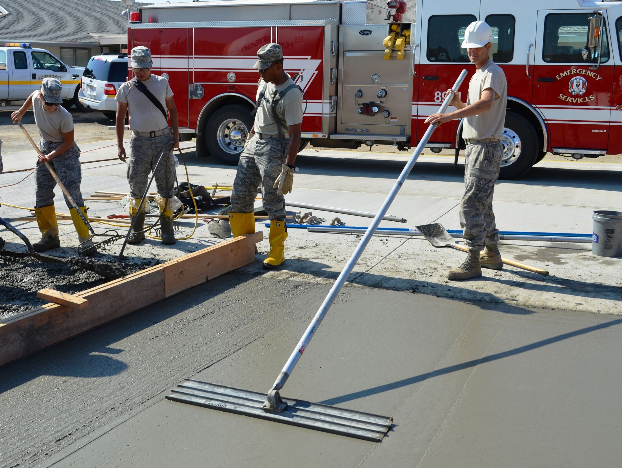 Master Sgt. Matthew Clement, 175th Civil Engineer Squadron structures craftsman, smoothes out freshly poured concrete. During a deployment for training, the 175th CES of the Maryland Air National Guard supported the California Army National Guard at Camp Roberts by constructing a concrete pad for the fire station, three range towers and renovating a dormitory. (National Guard photo)