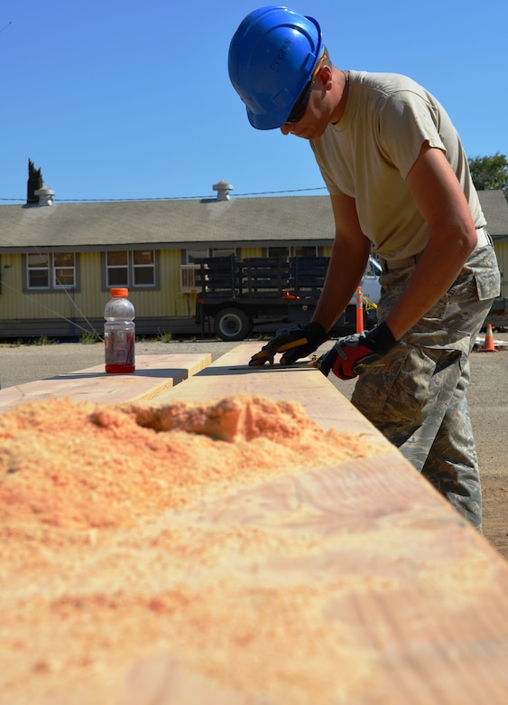 Senior Airman Andrew Bracken, 175th Civil Engineer Squadron structures apprentis, measures a 2 x 8 piece of wood for a stair well in a dormitory reconstruction project. During a deployment for training, the 175th CES of the Maryland Air National Guard supported the California Army National Guard at Camp Roberts by constructing a concrete pad for the fire station, three range towers and renovating a dormitory. (National Guard photo by Staff Sgt. Tabitha Gomes)