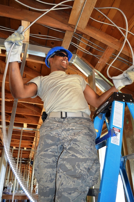 Senior Airman John Harper, 175th Civil Engineer Squadron heating ventilation air conditioning apprentice, runs electrical wire on the second floor of dormitory renovation. During a deployment for training, the 175th CES of the Maryland Air National Guard supported the California Army National Guard at Camp Roberts by constructing a concrete pad for the fire station, three range towers and renovating a dormitory. (National Guard photo by Staff Sgt. Tabitha Gomes)