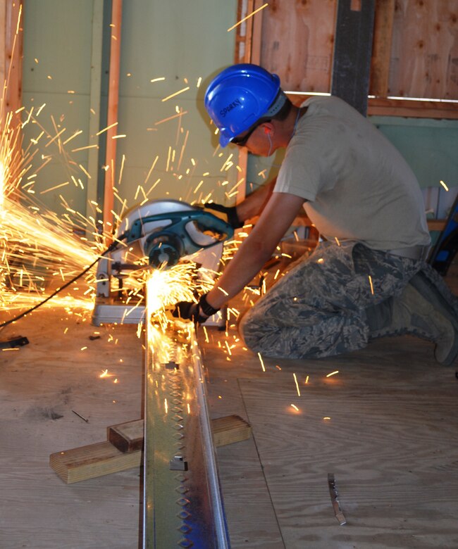 Senior Airman Andrew Bracken, 175th Civil Engineer Squadron structures apprentis, cuts metal studs for interior walls for a dormitory renovation. During a deployment for training, the 175th CES of the Maryland Air National Guard supported the California Army National Guard at Camp Roberts by constructing a concrete pad for the fire station, three range towers and renovating a dormitory. (National Guard photo by Staff Sgt. Tabitha Gomes)