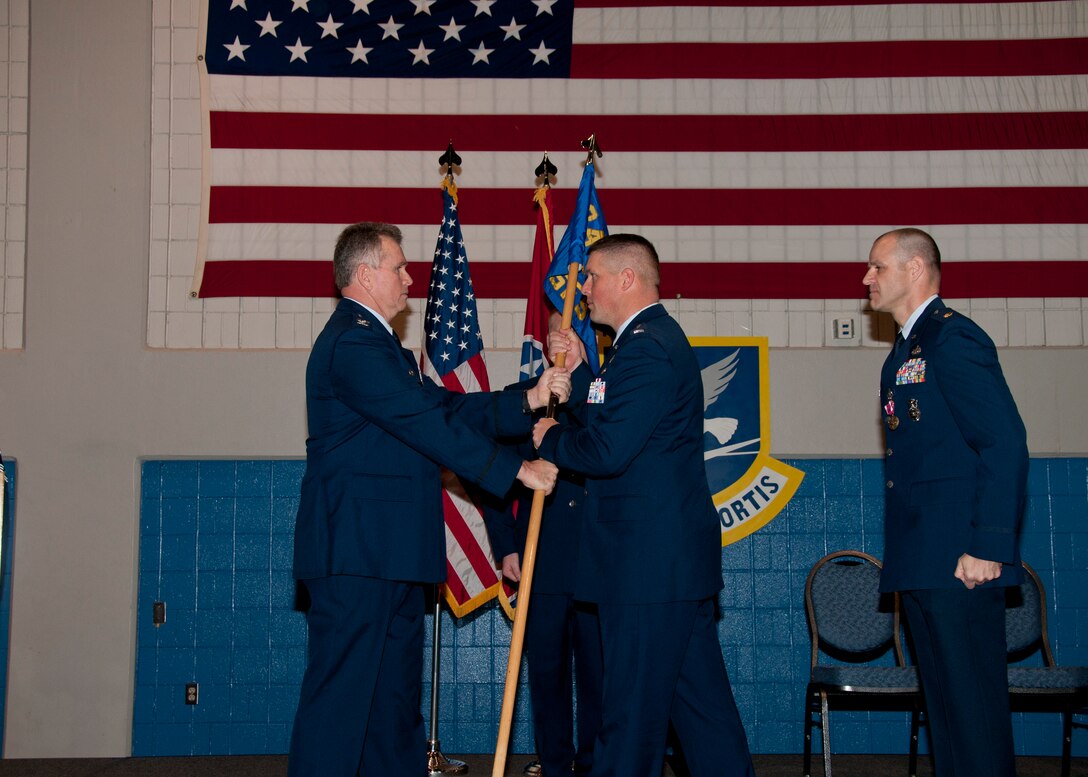 Capt. Art Douglass accepts the guidon from Col. Wallace Houser (Major Blanton is also pictured) and assumes command of the 134th ARW Security Forces Squadron (SFS) at the 134th ARW SFS Change of Command Ceremony on January 7, 2012.