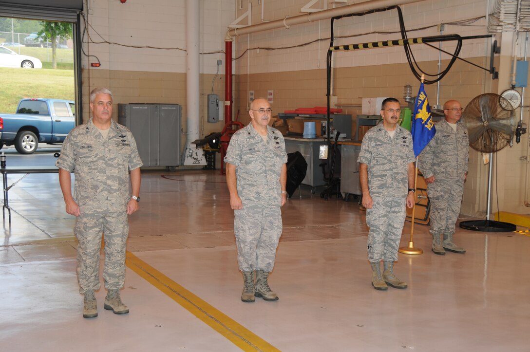 Wing Commander Colonel Thomas Cauthen, Vice Commander Colonel Randall Gratz, Colonel Burl Lambert and Senior Master Sgt. Richard Henderson stand at attention at the Maintenance Change of Command Ceremony on August 7, 2011.