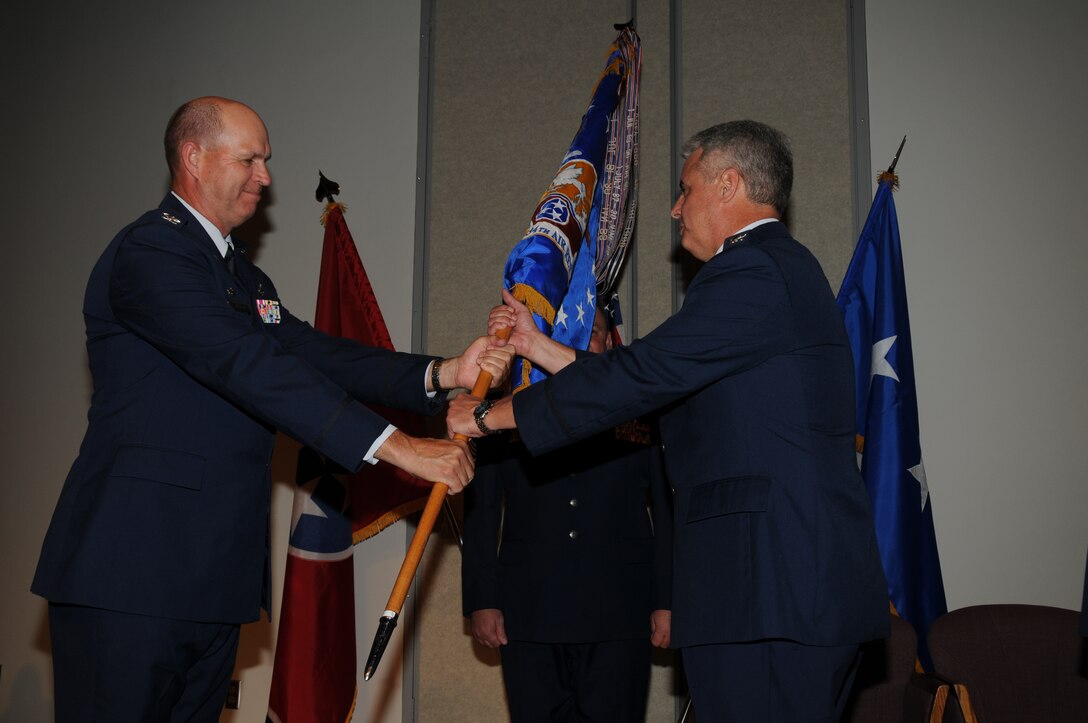 Brg. Gen. Don Johnson passes the guidon to the new 134th Air Refueling Wing Commander, Col. Thomas Cauthen, at the 13th ARW Change of Command on June , 2011 (also pictured Command Chief Master Sgt. Jimmy Long).