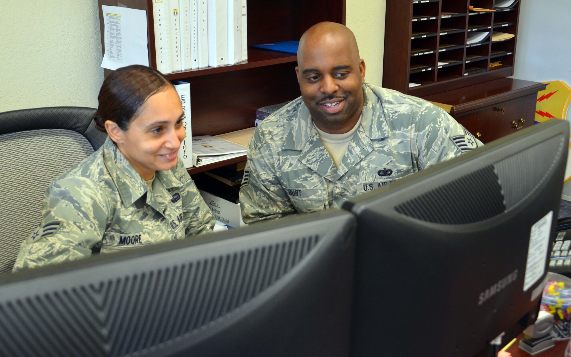 Staff Sgt. Terrance Burt, non commissioned officer in charge of the 920th Rescue Wing commander's support staff, assists Senior Airman Maritza Moore in preparing some records for inspection.  Burt leads a three-person team responsible for overseeing all records management of the wing staff. (U.S. Air Force Photo/Capt. Ryan Liss)