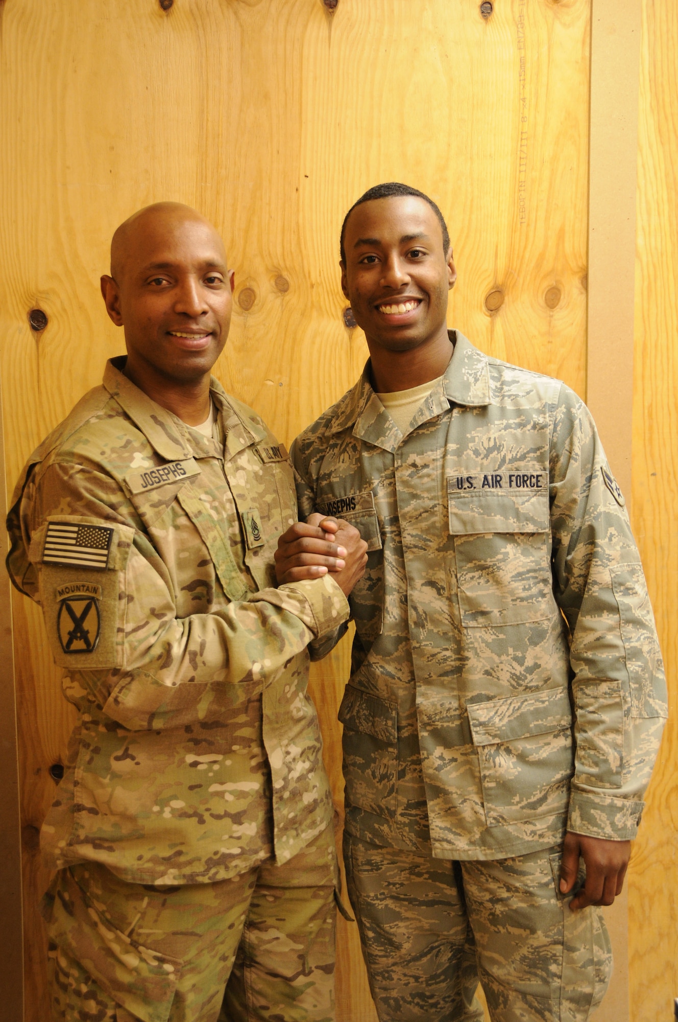 Father, 1st. Sgt. Walter Josephs Jr., a field artillery instructor with the Army, and son, Airman 1st Class, Walter Josephs Jr., a 451st Air Expeditionary Wing services journeyman visit together at Kandahar Airfield, Feb. 6, 2012, (U.S. Air Force photo by Staff Sgt. Heather Skinkle)
