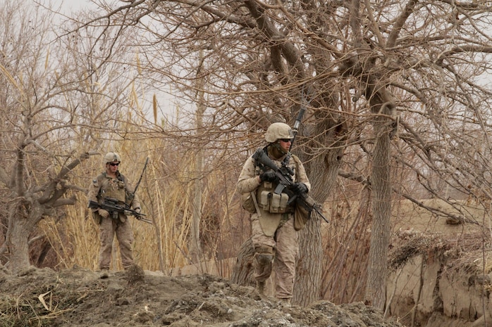 Lance Cpl. Dakota M. Landrie (left), an automatic rifleman with India Company, 3rd Battalion, 7th Marine Regiment, and Lance Cpl. William M. Baldridge (right), a radio operator with, India Co., patrol here recently. Landrie, a 19-year-old native of Indian Land, S.C., and 2010 graduate of Indian Land High School, and Baldridge, a 22-year-old native of Palmdale, Calif., traversed steep terrain to take a new route to the surrounding farmland.