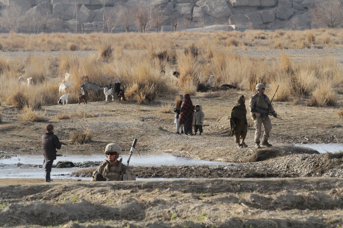 Marines from 2nd Squad, 1st Platoon, India Company, 3rd Battalion, 7th Marine Regiment, move through grazing areas during a security patrol here recently. During the past two years, Afghan National Army soldiers and Marines cleared the area of insurgents and developed positive relations with local villagers.