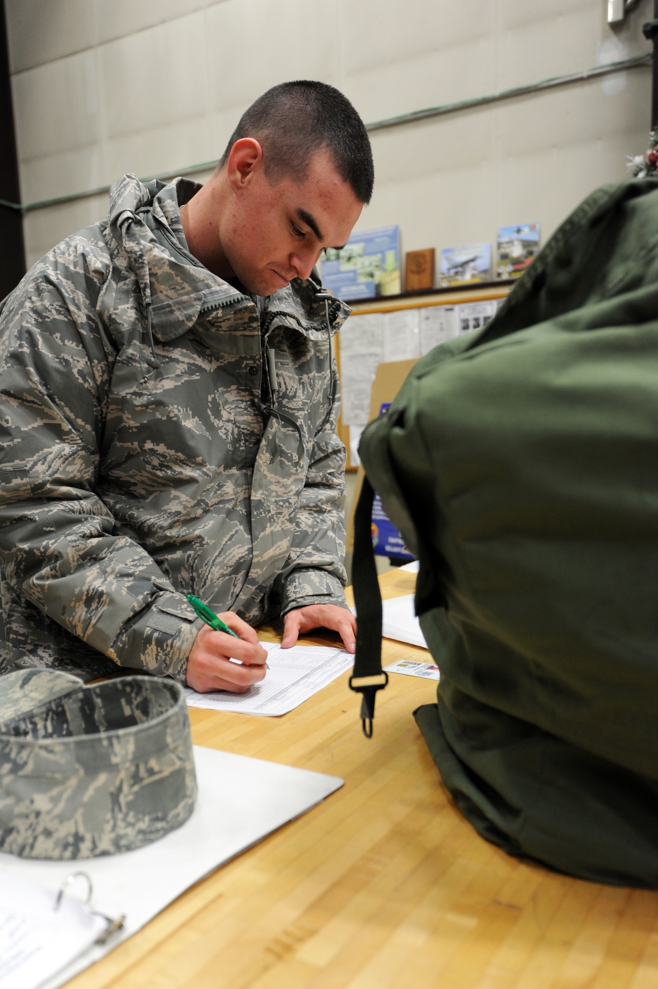 MISAWA AIR BASE, Japan -- Airman 1st Class Bradley Stevens, 35th Civil Engineer Squadron water and fuel systems maintenance apprentice, signs for his Mission Oriented Protective Posture training gear in the Individual Protective Equipment warehouse here, Feb. 9. MOPP training gear is issued to all servicemembers at Misawa. (U.S. Air Force Photo/Airman 1st Class Kia Atkins)