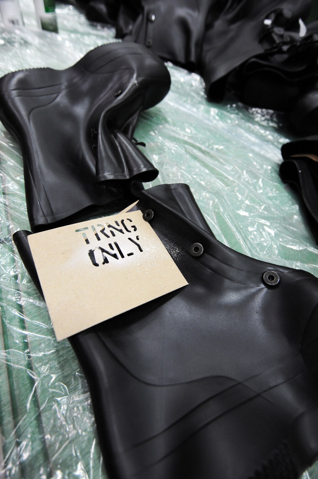 MISAWA AIR BASE, Japan -- Mission Oriented Protective Posture training boots are spray painted as training equipment in the Individual Protective Equipment warehouse here, Feb. 9. Once MOPP gear, used to protect Airmen against chemical, biological, radiological and nuclear attacks, reaches the expiration date on its effectiveness, it is then used for training purposes only. (U.S. Air Force photo/Airman 1st Class Kia Atkins)