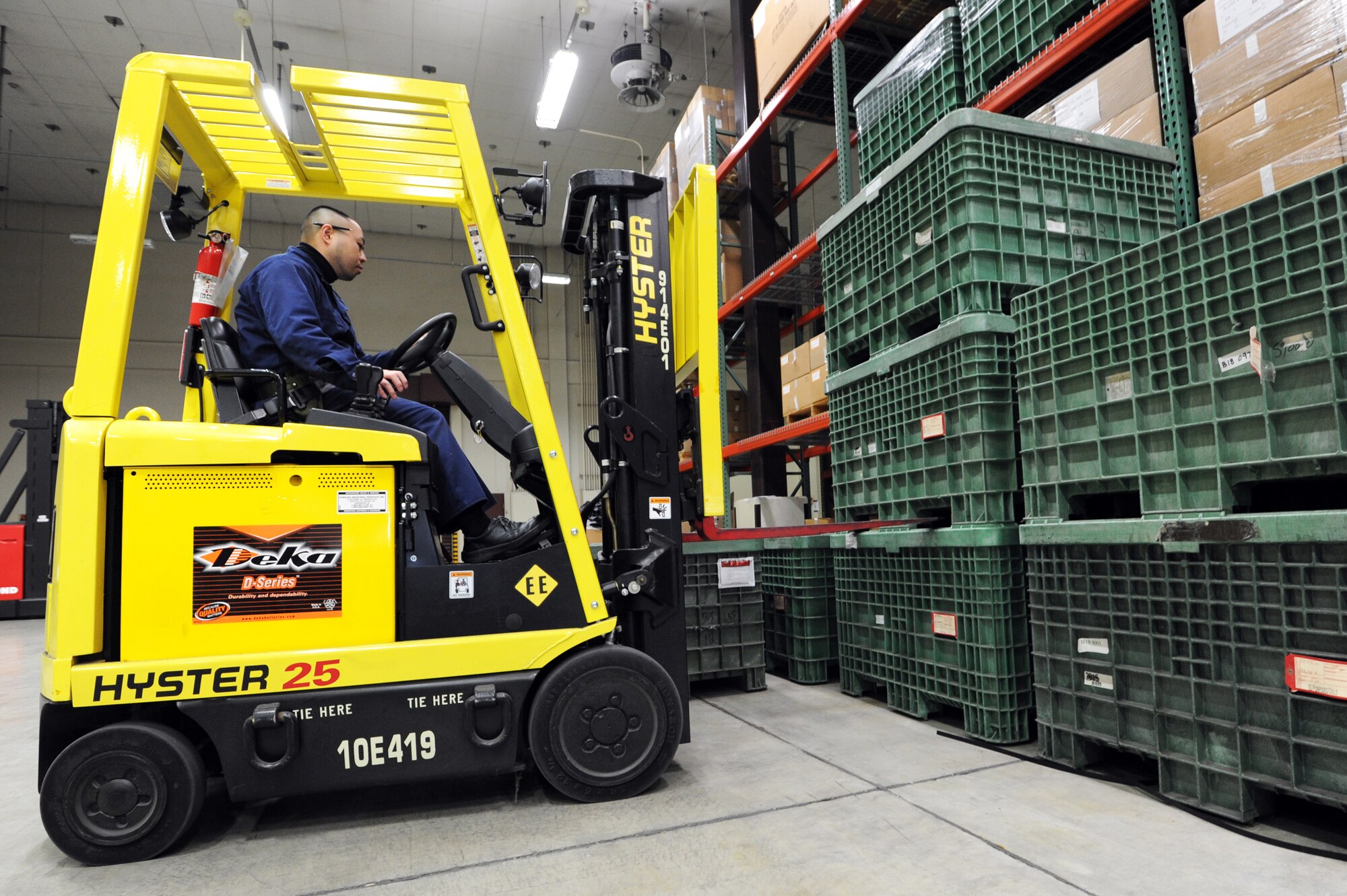 MISAWA AIR BASE, Japan -- Koichi Saito, 35th Logistics Readiness Squadron warehouseman, moves crates in the Individual Protective Equipment warehouse here, Feb. 9. The crates contain Mission Oriented Protective Posture equipment for servicemembers to use in training for a chemical, biological, radiological or nuclear attack. (U.S. Air Force photo/Airman 1st Class Kia Atkins)