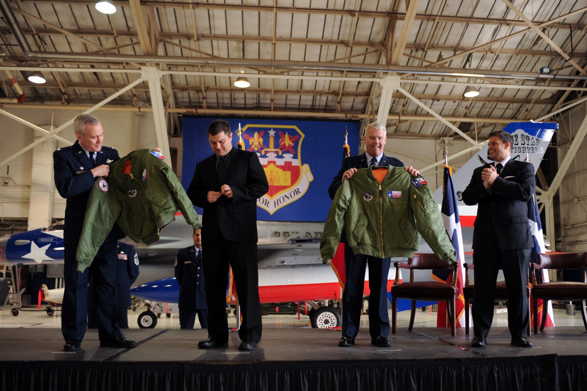 Cols. John Kane (left) and Michael Kelley (second from right), commander and vice commander of the 149th Fighter Wing, respectively, welcome Jason Lohe (second from left) owner and chief executive officer, and Cree Crawford (right), president and chief operating operator, both of the San Antonio Talons professional arena football team, as ?Honorary Commanders? of the Texas Air National Guard unit at Lackland Air Force Base, Texas, Feb. 11, 2012. (National Guard photo by Staff Sgt. Eric Wilson / Released)