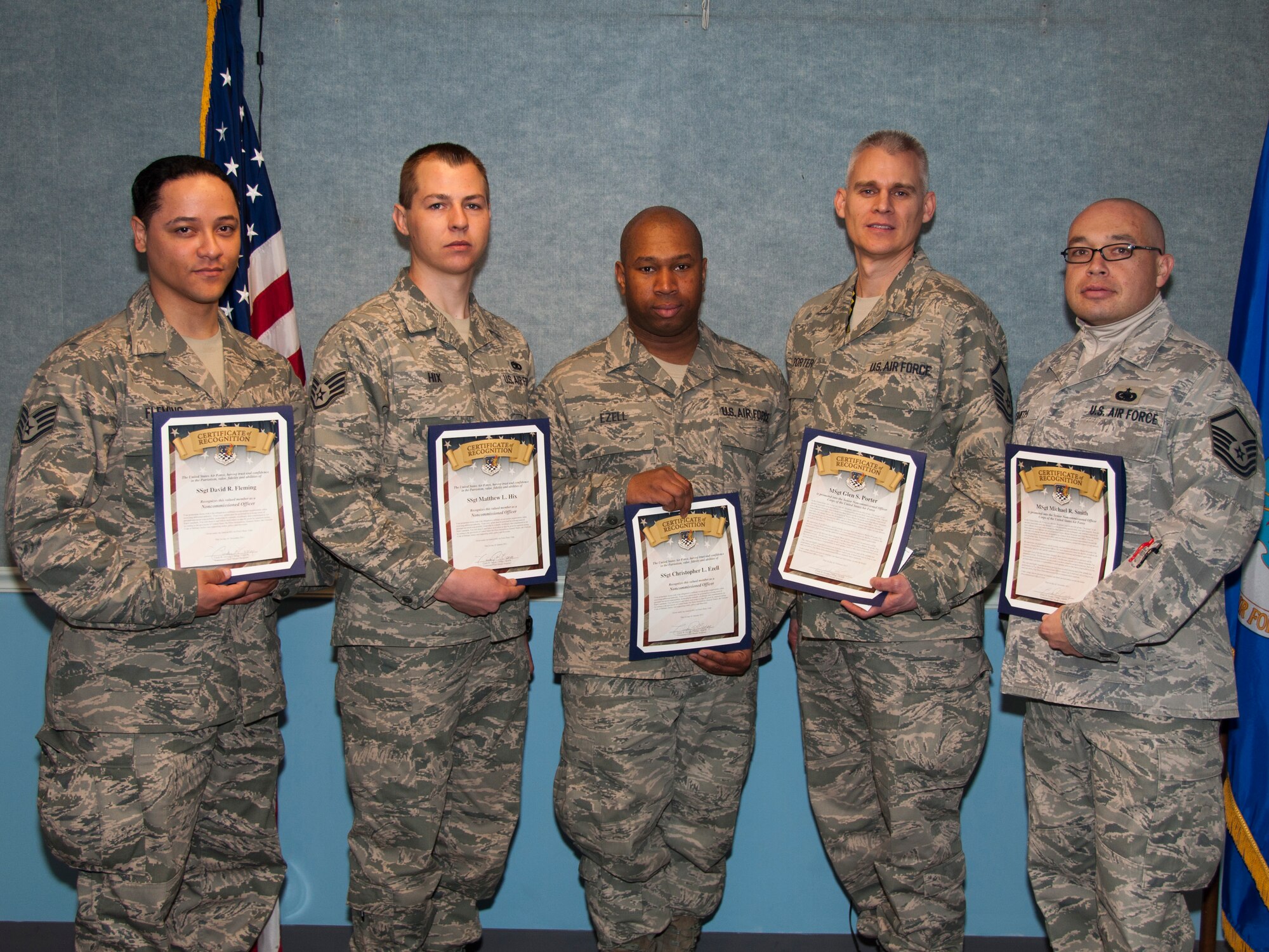 A group of newly-promoted NCOs and senior NCOs pose for a photo. From left to right,  Staff Sgt. David Fleming, Staff Sgt. Matthew Hix, Staff Sgt. Christopher Ezell, Master Sgt. Glen Porter, and Master Sgt. Michael Smith. (U.S. Air Force photo/Staff Sgt. Kyle Brasier)