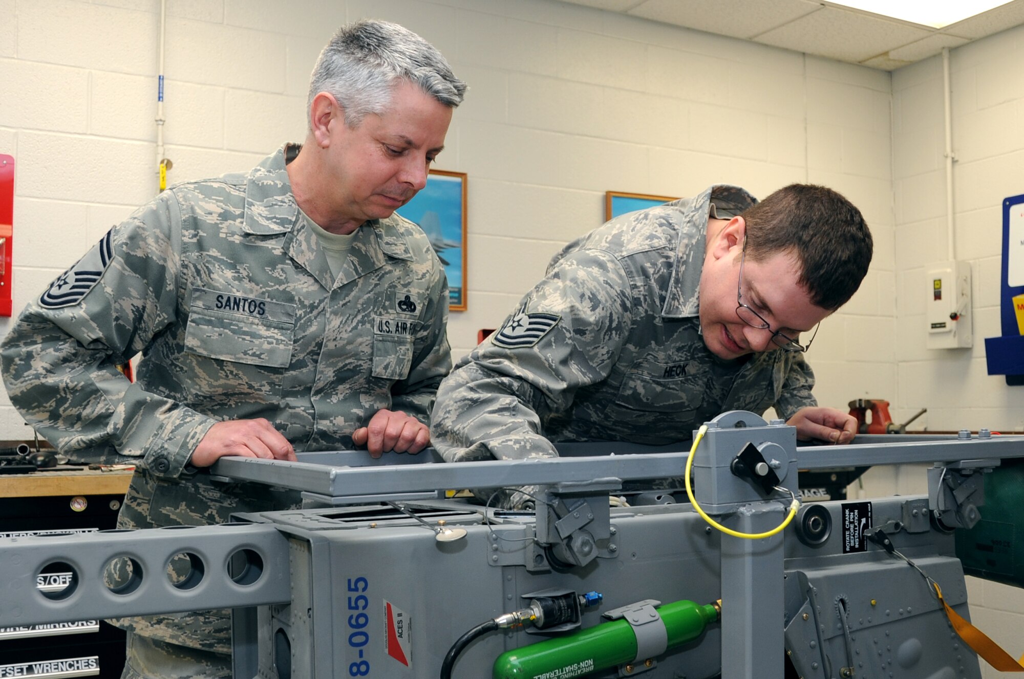 Senior Master Sgt. Roy Santos, 442nd Maintenance Squadron accessory flight chief, observes Tech. Sgt Andrew Heck, 442nd Maintenance Squadron egress technician, during a walkthrough of the Egress shop, Feb. 12, 2012 here. Senior Master Sgt. Santos is the 2011 Lt. Gen. Leo Marquez award winner. (U.S. Air Force photo/Staff Sgt Lauren Padden) 