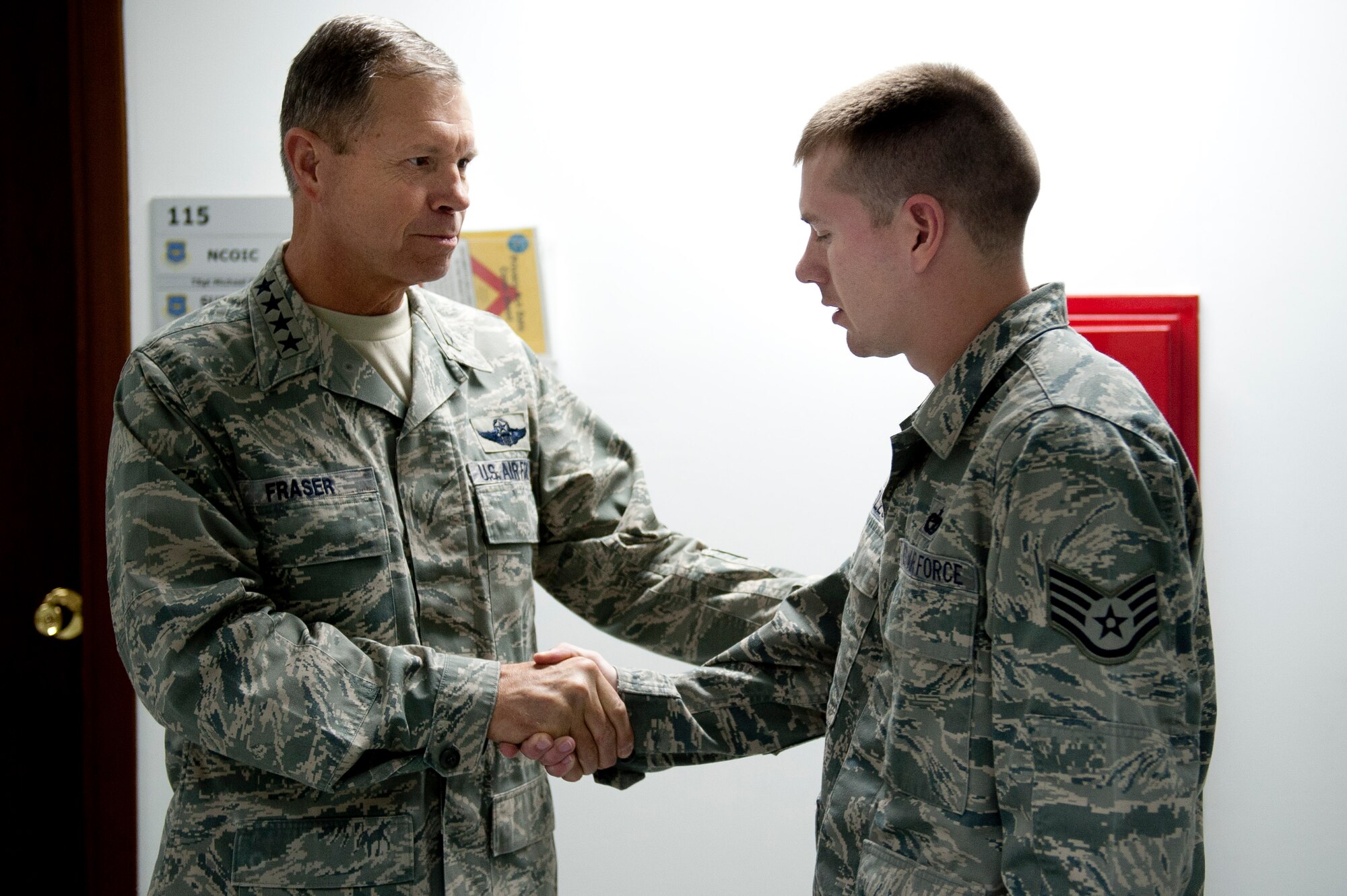 Gen. William M. Fraser III, U.S. Transportation Command commander, left, speaks with Staff Sgt. Elliot Huddleston, 39th Logistics Readiness Squadron, about his recent contributions to the 728th Air Mobility Squadron Feb. 9, 2012, at Incirlik Air Base, Turkey. Fraser received a briefing from wing leadership, toured several base facilities and visited with Airmen to thank them for their hard work. (U.S. Air Force photo by Tech. Sgt. Michael B. Keller/Released)