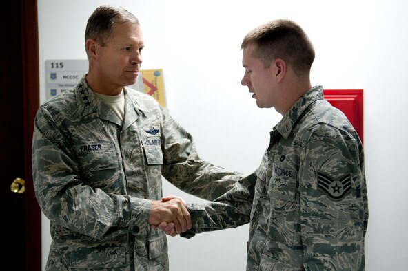 Gen. William M. Fraser III, U.S. Transportation Command commander, left, speaks with Staff Sgt. Elliot Huddleston, 39th Logistics Readiness Squadron, about his recent contributions to the 728th Air Mobility Squadron Feb. 9, 2012, at Incirlik Air Base, Turkey. Fraser received a briefing from wing leadership, toured several base facilities and visited with Airmen to thank them for their hard work. (U.S. Air Force photo/Tech. Sgt. Michael B. Keller)(Released)