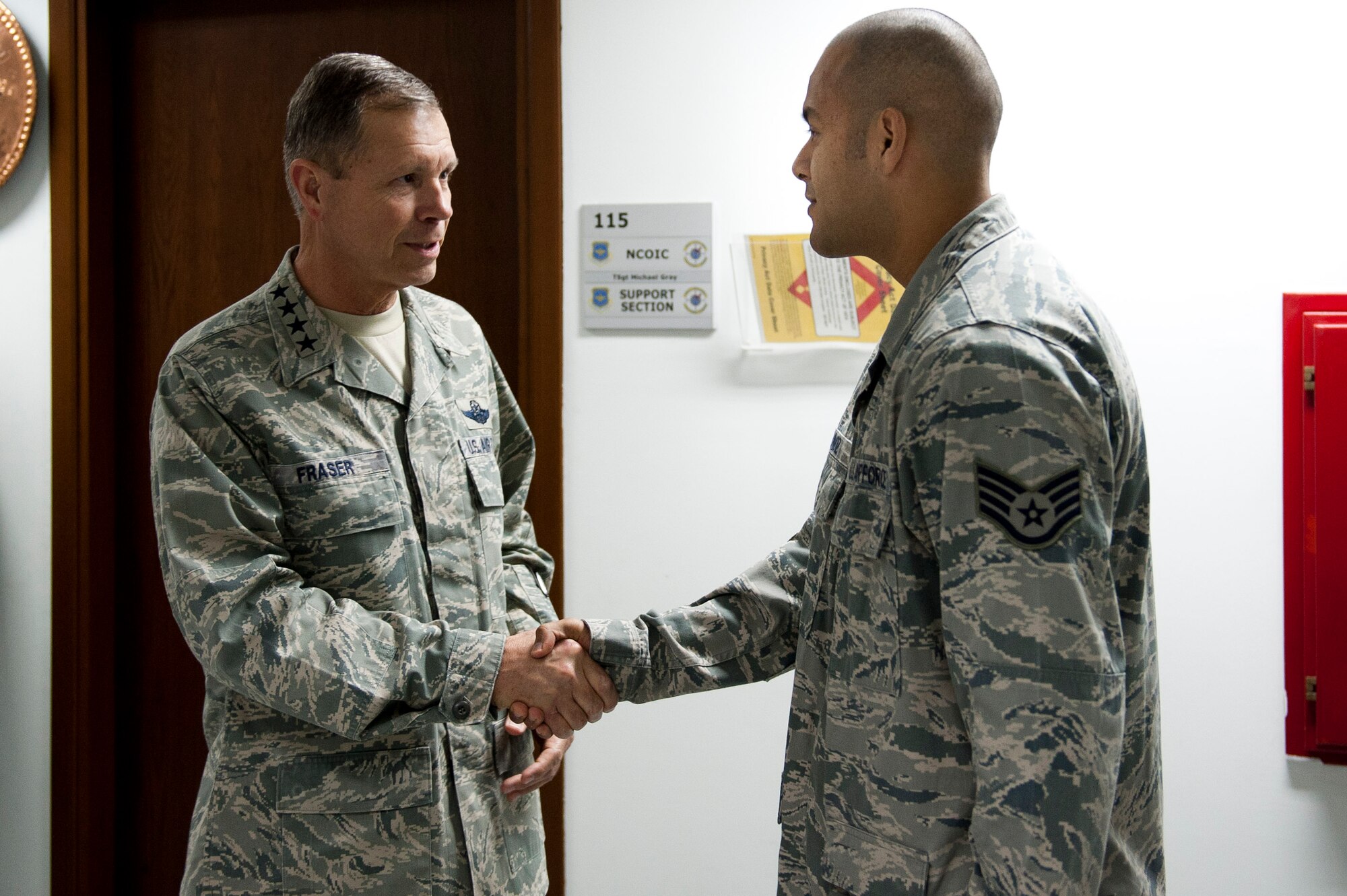 Gen. William M. Fraser III, U.S. Transportation Command commander, left, speaks with Staff Sgt. Juan Munoz, 728th Air Mobility Squadron, about his recent contributions to the squadron Feb. 9, 2012, at Incirlik Air Base, Turkey. Fraser received a briefing from wing leadership, toured several base facilities and visited with Airmen to thank them for their hard work. (U.S. Air Force photo by Tech. Sgt. Michael B. Keller/Released)