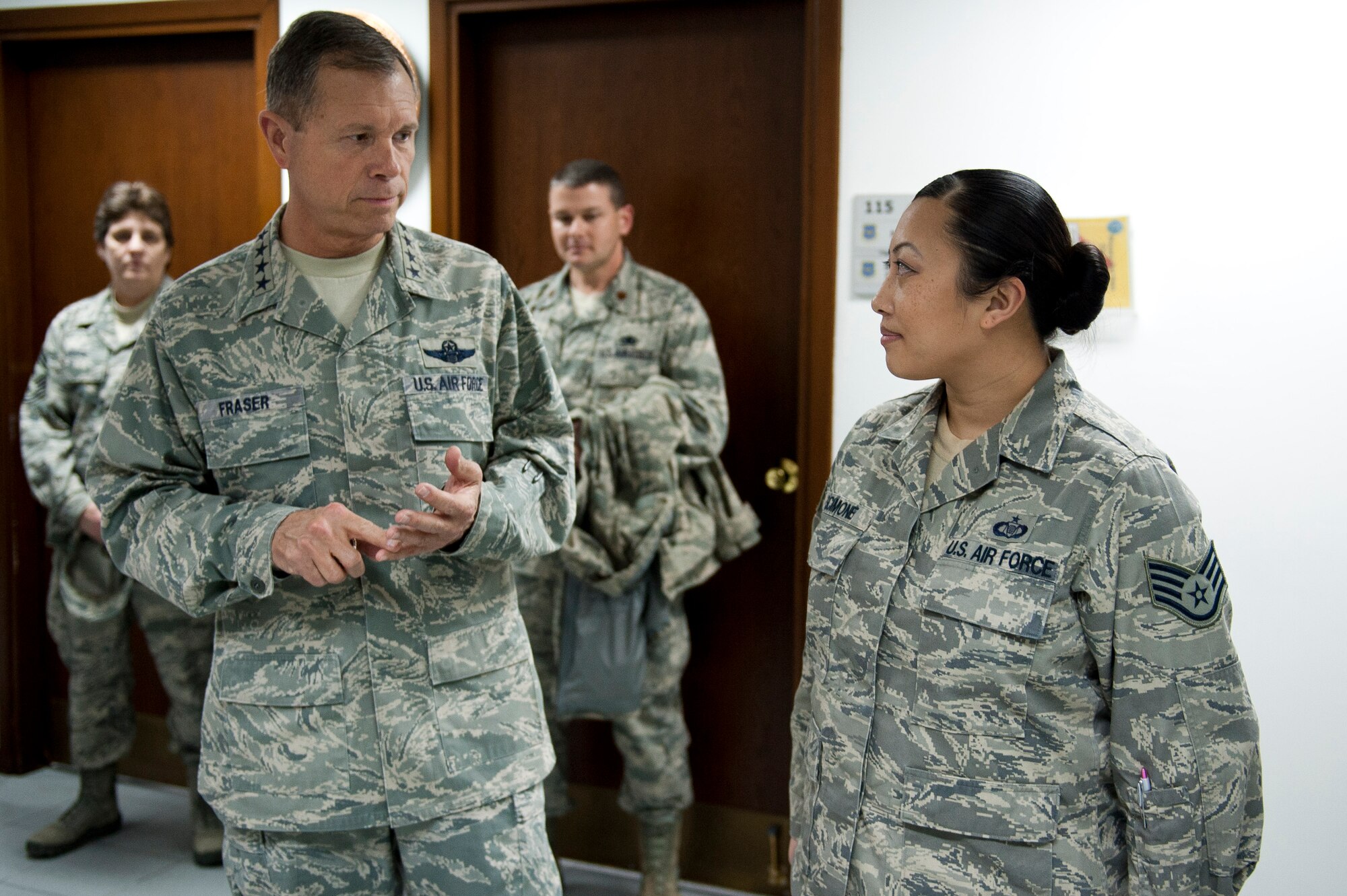 Gen. William M. Fraser III, U.S. Transportation Command commander, left, speaks with Staff Sgt. May Scimone, 728th Air Mobility Squadron, about her recent contributions to the squadron Feb. 9, 2012, at Incirlik Air Base, Turkey. Fraser received a briefing from wing leadership, toured several base facilities and visited with Airmen to thank them for their hard work. (U.S. Air Force photo by Tech. Sgt. Michael B. Keller/Released)
