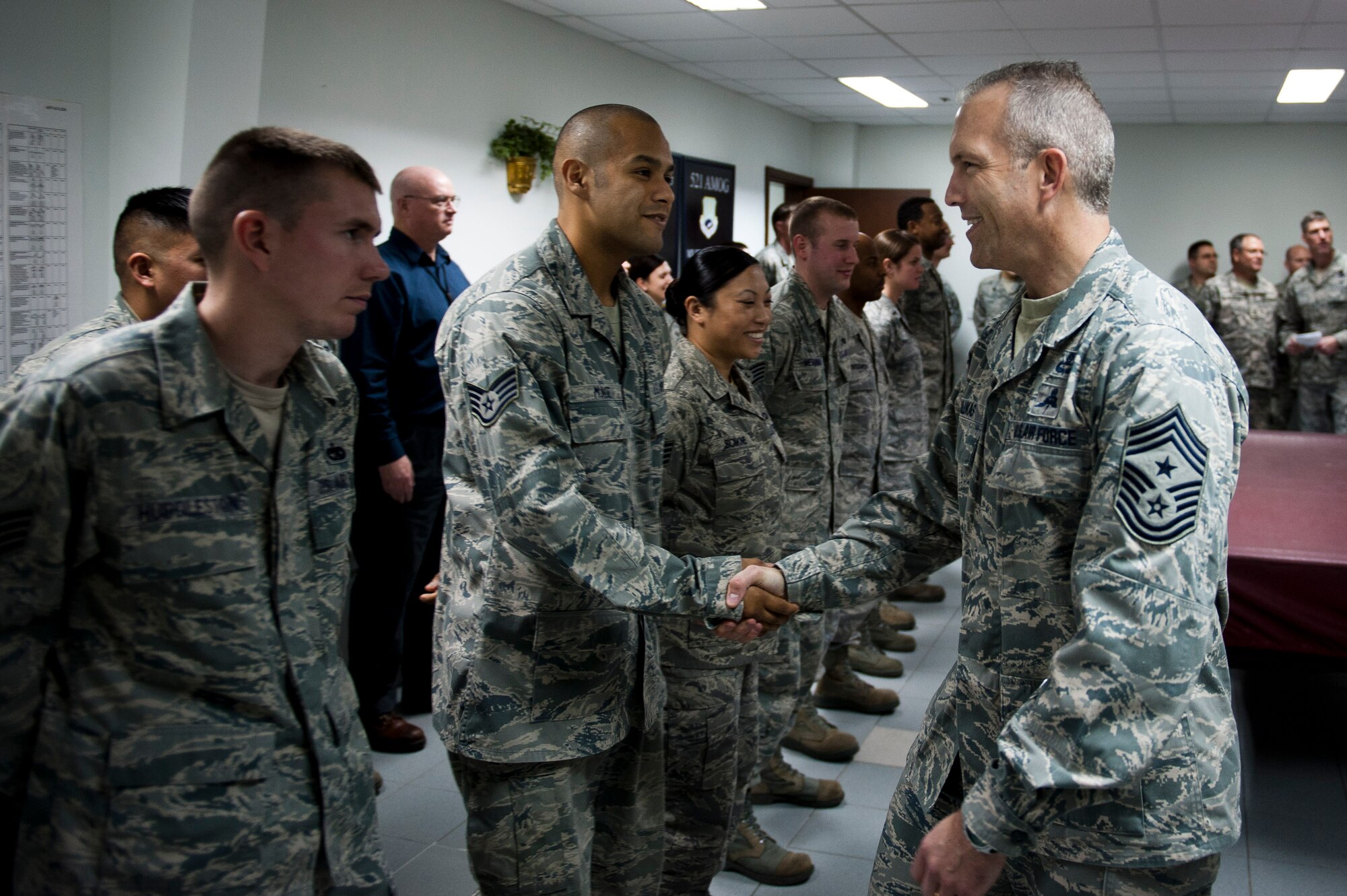Chief Master Sgt. Martin Klukas, U.S. Transportation Command senior enlisted leader, shakes hands with 728th Air Mobility Squadron Airmen Feb. 9, 2012, at Incirlik Air Base, Turkey. Klukas toured Incirlik with Gen. William M. Fraser III, U.S. Transportation Command commander, where they received a briefing from wing leadership, visited several base facilities and spoke with Airmen to thank them for their hard work. (U.S. Air Force photo by Tech. Sgt. Michael B. Keller/Released)