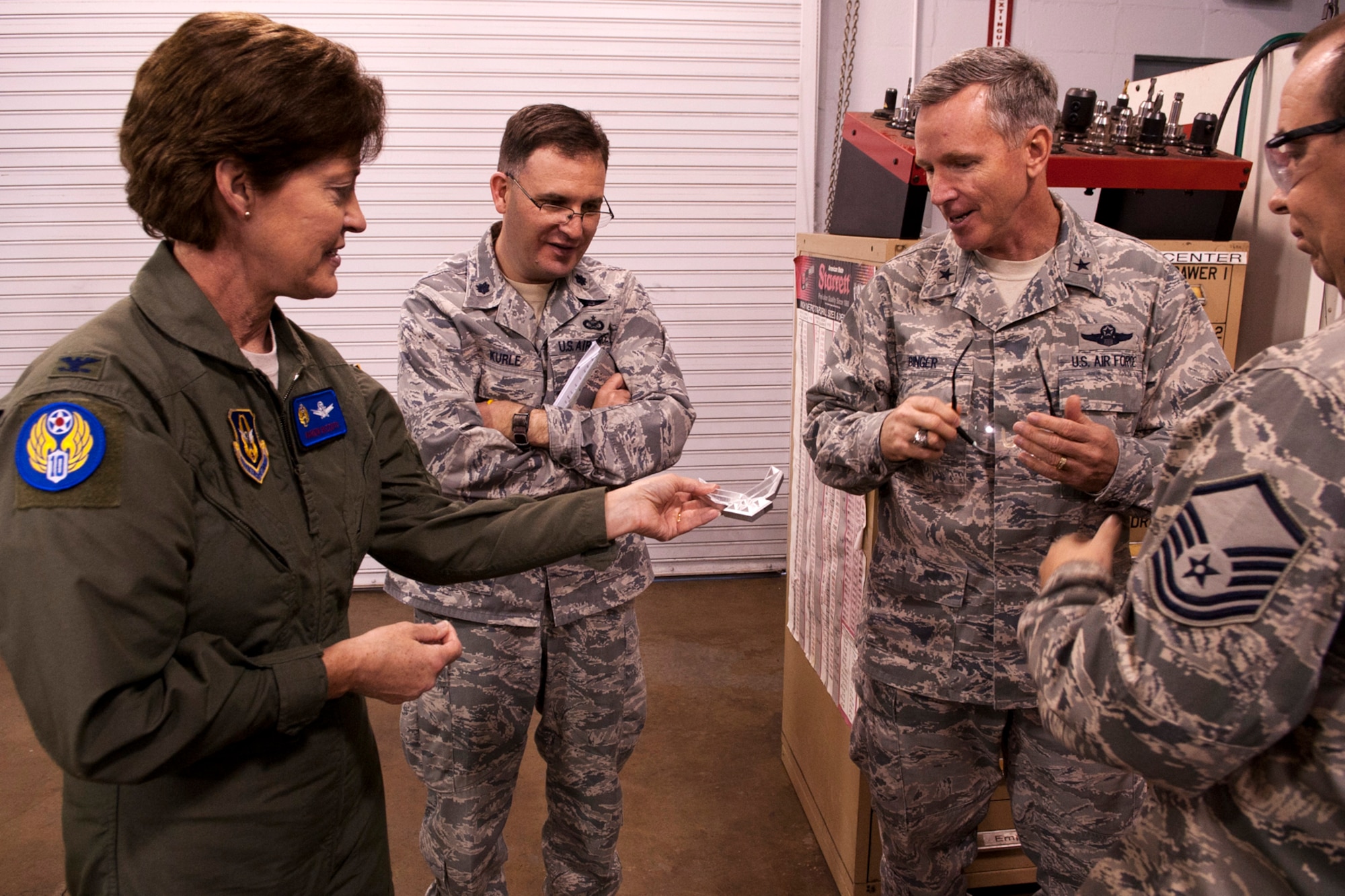 U.S. Air Force Col. Karen Rizzuti, 10th Air Force vice commander, holds an aluminum cut-out of the Air Force logo created on the Computer Numerically Controlled Milling Machine, Barksdale Air Force Base, La., Feb. 10,2012. Rizzuti accompanied Brig. Gen. William Binger, 10th AF commander, during his visit to Barksdale. (U.S. Air Force photo by Master Sgt. Greg Steele/Released)