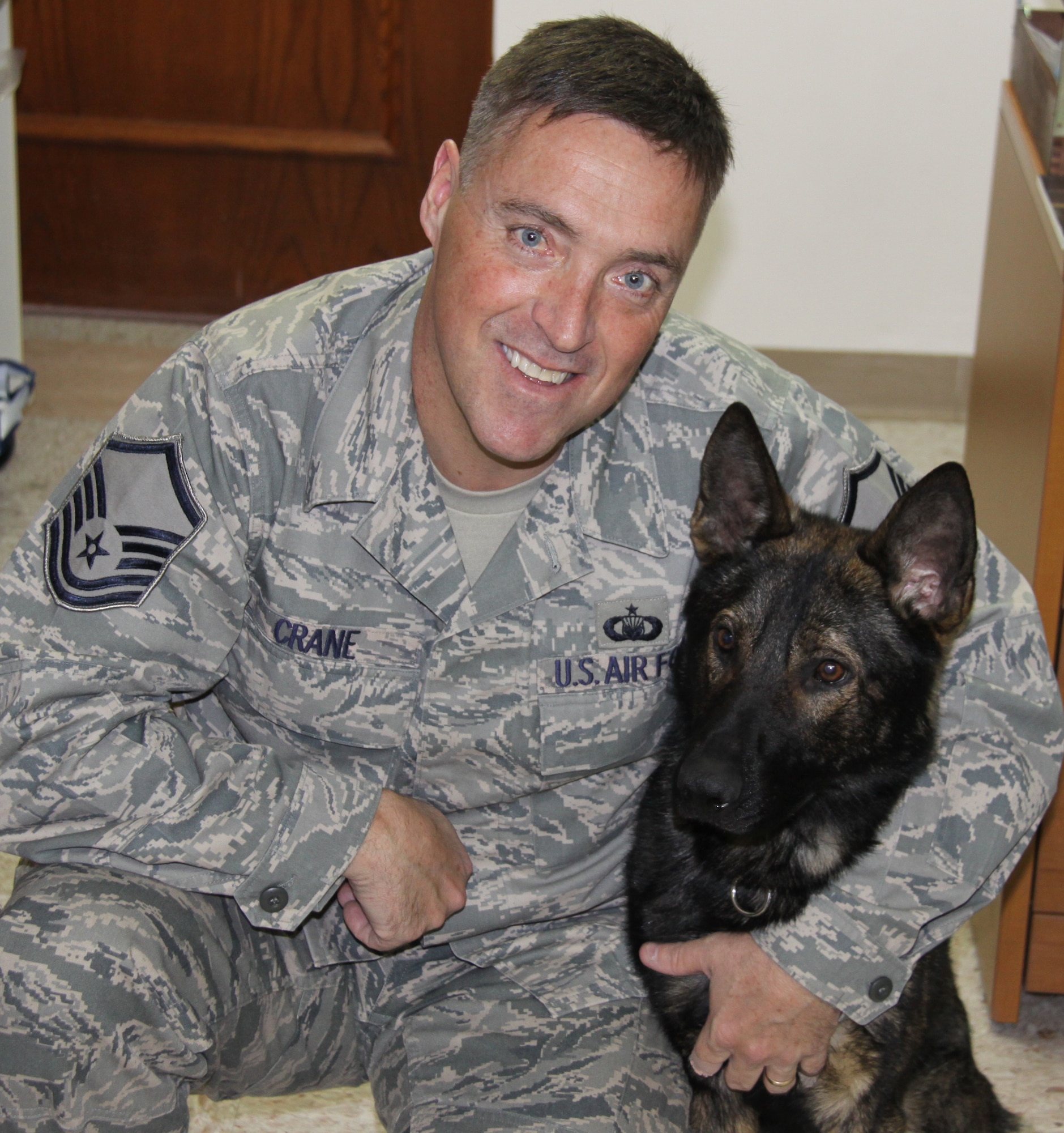 Master Sgt. Tim Crane, 911th Airlift Wing chaplain’s assistant, with new partner, Sonic, a 20-month-old German Shepherd.  Crane works in the K9 unit for the Pittsburgh Police Department.  He and Sonic will spend the next three months side-by-side learning explosive detection at the Pittsburgh Police Academy.  (U.S. Air Force photo Master. Sgt. Mark Winklosky/Released)
