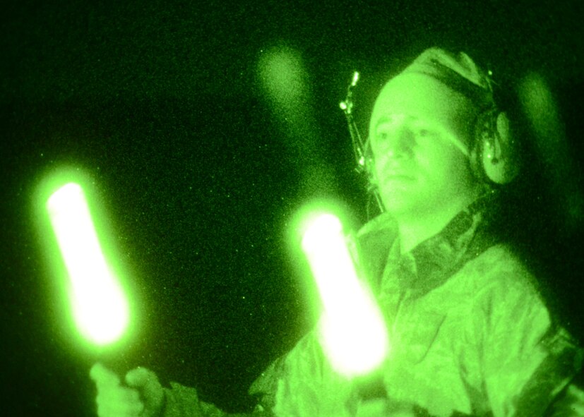 Senior Airman Randall Hearrell, 757th Aircraft Maintenance Squadron, Nellis Air Force Base, directs an A-10C assigned to the Maryland Air National Guard during nighttime exercises at Mud Lake on the Nevada Test and Training Range, November 29, 2011. The NTTR is comprised of 2.9 million acres and nearly 15,800 square miles of airspace, which provide year-round training to U.S. and allied aircrews.  (National Guard photo by Staff Sgt. Benjamin Hughes/RELEASED)