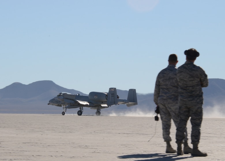 Members of the 757th Aircraft Maintenance Squadron, Nellis Air Force Base, watch a Maryland Air National Guard A-10C lands at Mud Lake on the Nevada Test and Training Range, November 29, 2011. The NTTR is comprised of 2.9 million acres and nearly 15,800 square miles of airspace, which provide year-round training to U.S. and allied aircrews. (National Guard photo by Staff Sgt. Benjamin Hughes/RELEASED)