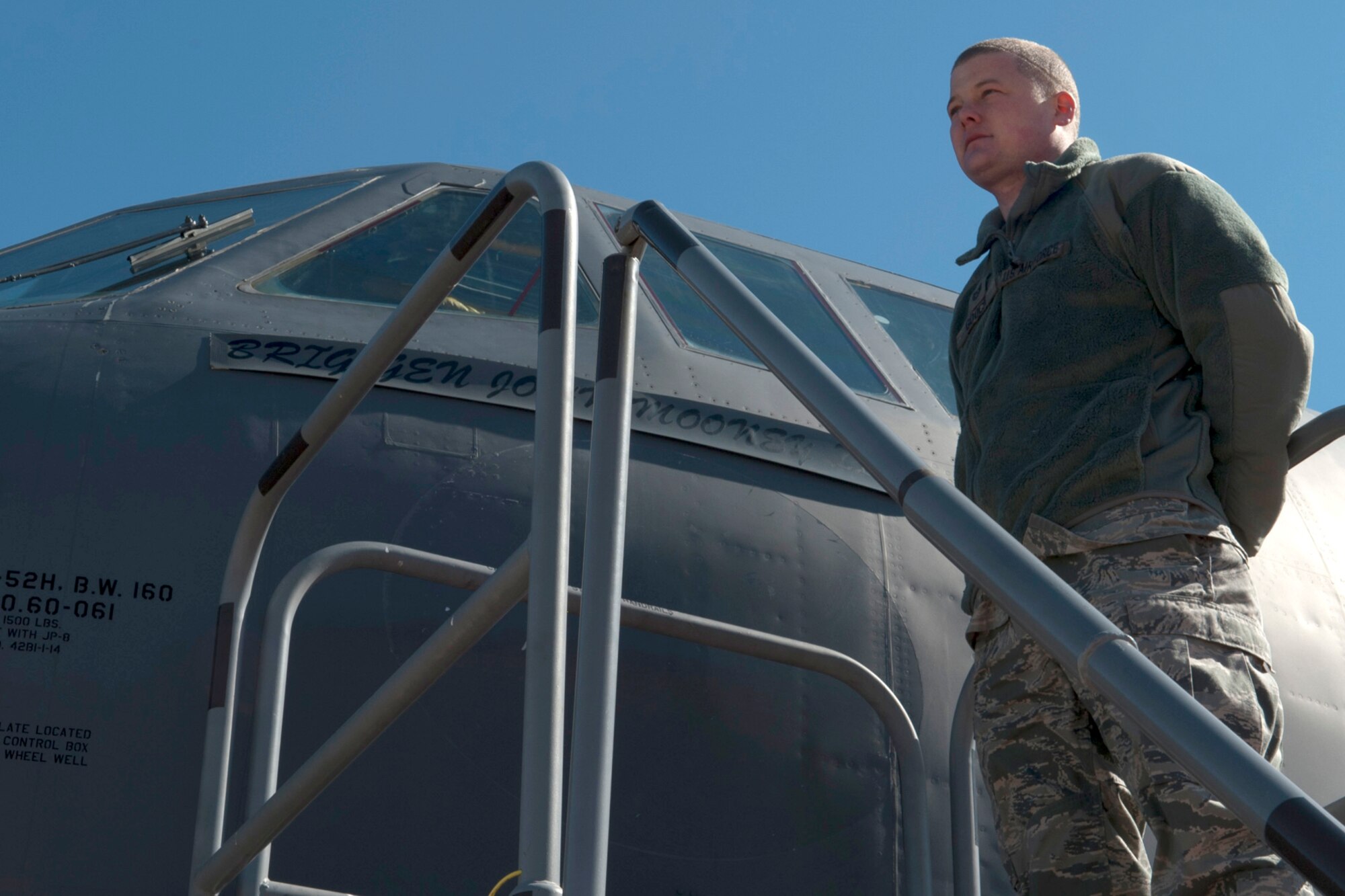 U.S. Air Force Tech. Sgt. Thomas Gooch, 2nd Aircraft Maintenance Squadron crew chief, stands ready to remove Brig. Gen. John Mooney III's name from B-52 60-061 following a Change of Command ceremony, Barksdale Air Force Base, La., Feb. 11, 2012. Lt. Col Jonathan Ellis assumed command of the 307th Bomb Wing and the unveiling of his name followed the ceremony. (U.S. Air Force photo by Master Sgt. Greg Steele/Released)